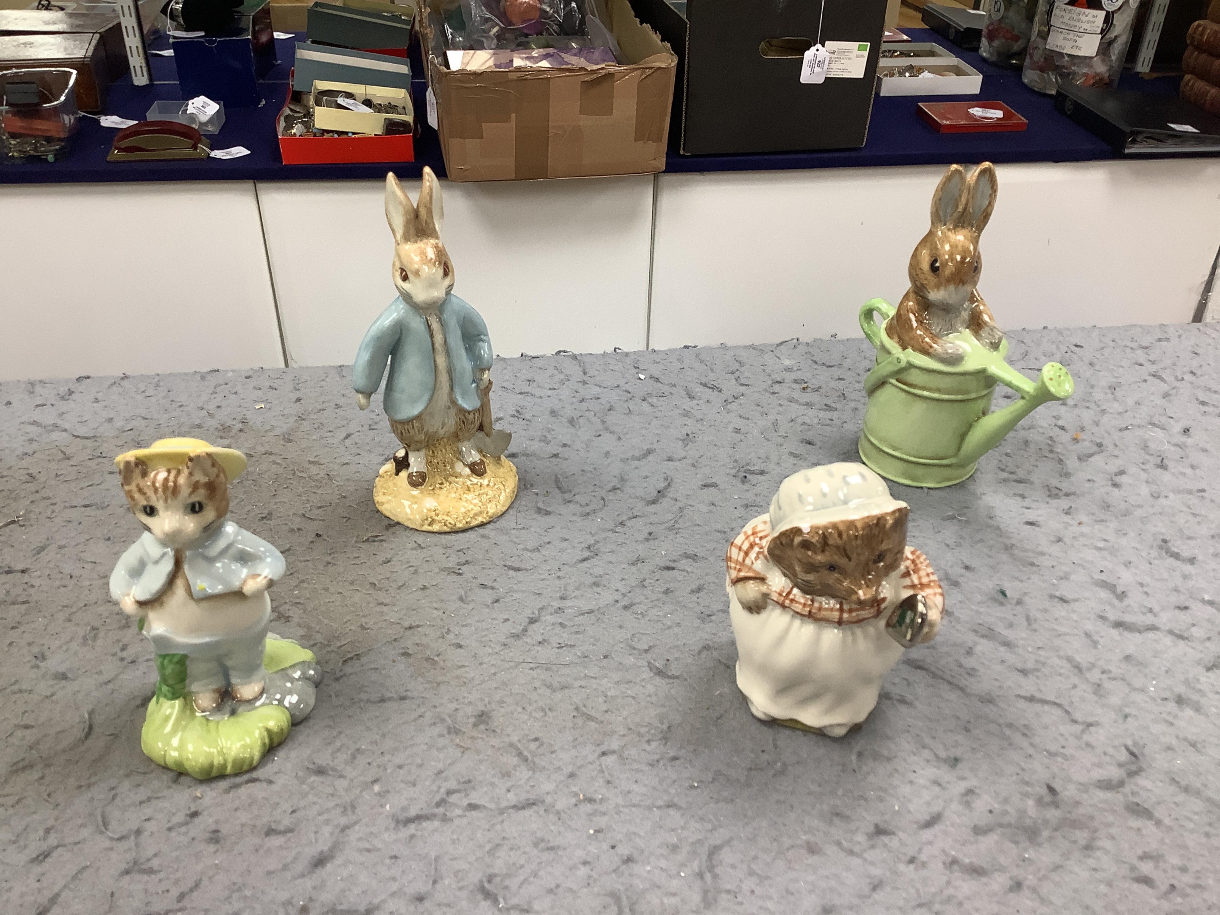 Sixteen John Beswick Beatrix Potter figures, including Jemima and her Ducklings, Peter in the watering can and Mrs Tiggywinkle Washing, all boxed. Condition - fair to good